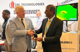 Rajesh Alla, Chairman & Managing Director of IIC Technologies, receiving a presentation from the Director Jamie McMichael-Philips, in front of IIC booth at the IHO General Assembly in Monaco Apr 2026.